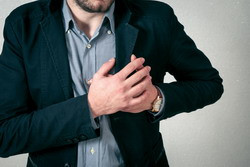 Man clutching chest with pain