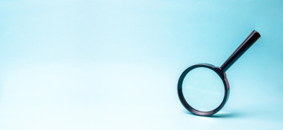 Magnifying glass on blue background
