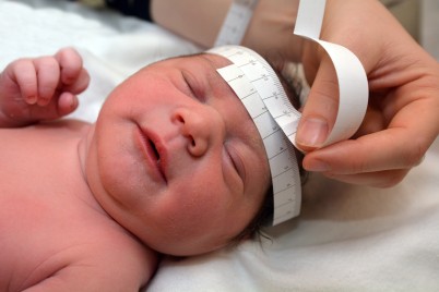 Baby having head circumference measured