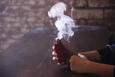 Vaping device or e-cigarette in hand