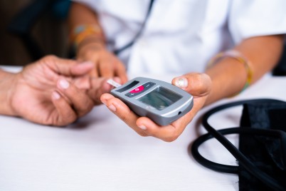 Healthcare delivery concept image of doctor testing patient's sugar level